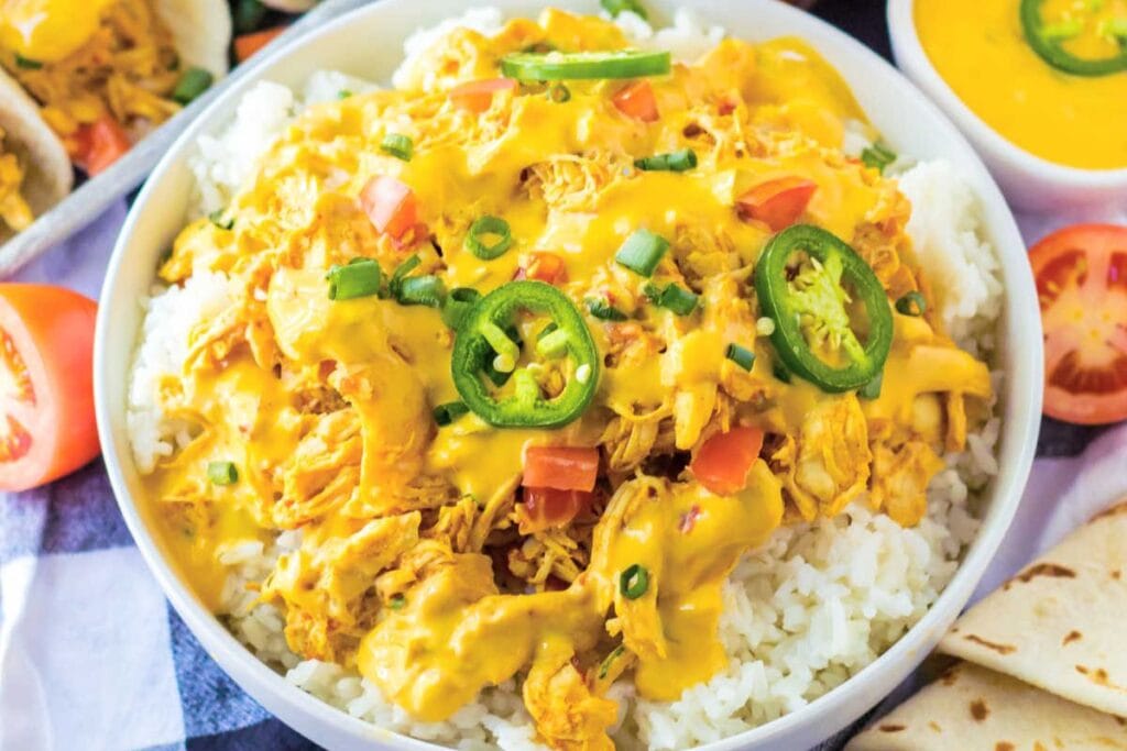 Chicken with cheese and rice in a bowl.