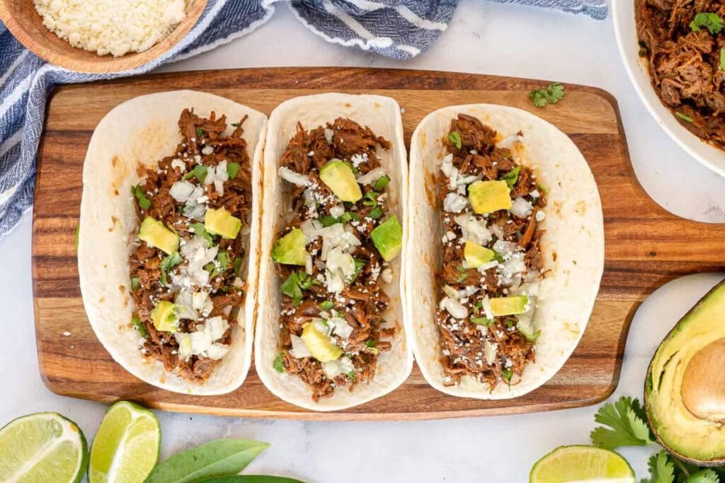 Tacos on a wooden board.