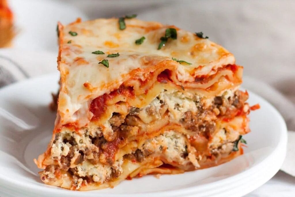 A slice of lasagna on a plate.