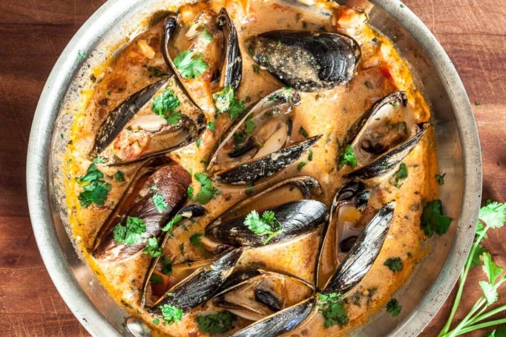 Curry mussels in a pot.