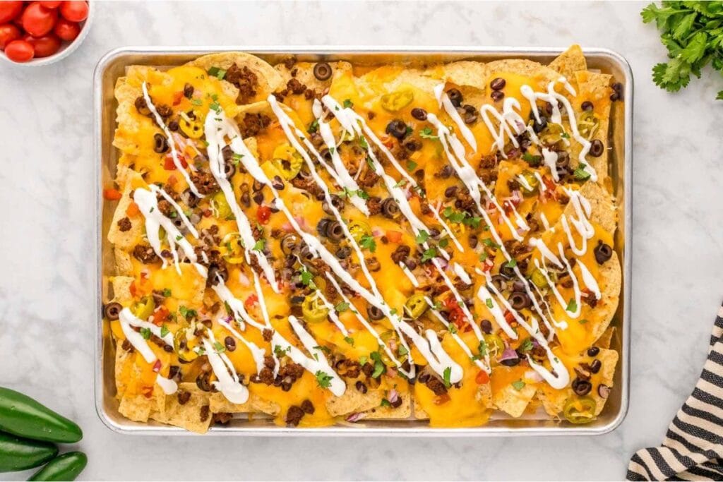 Sheet pan nachos on baking tray.