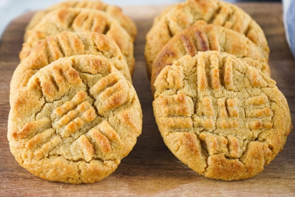 Peanut butter cookies on a wooden board.