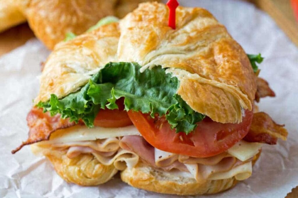 Croissant sandwich close up shot.