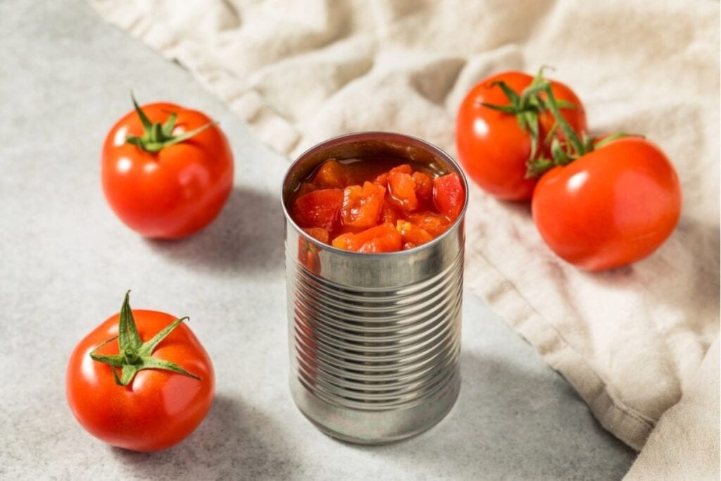Canned tomatoes on a white surface.