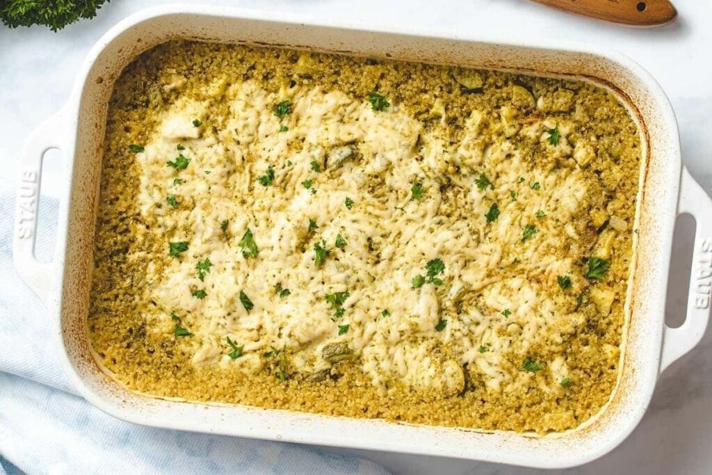 Chicken and zucchini casserole in a white dish.