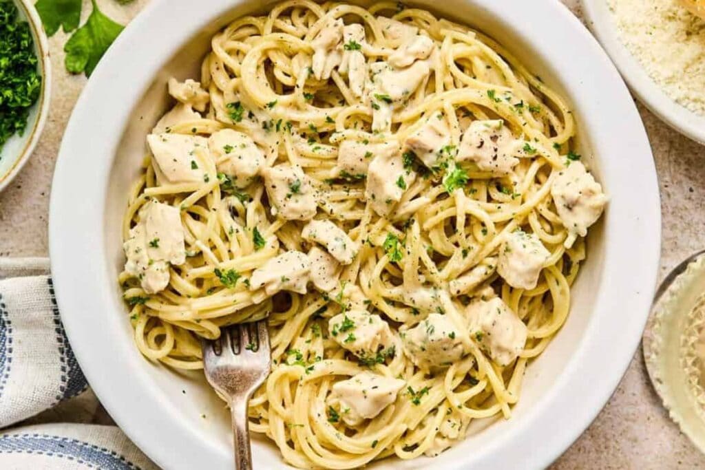 Chicken alfredo on a plate.