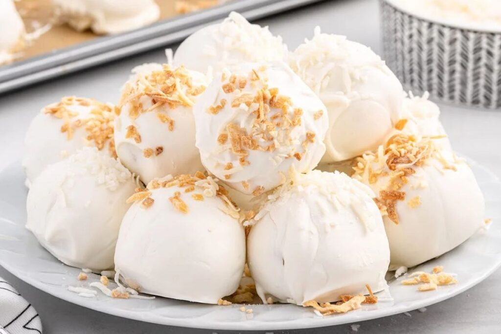 Coconut cheesecake bites on a plate.