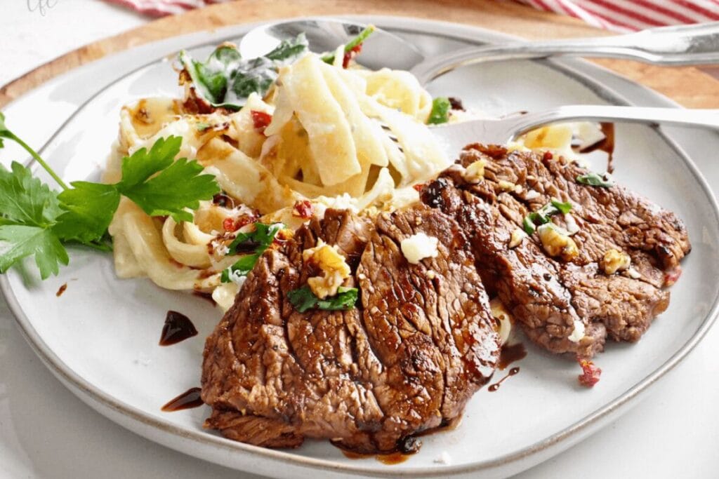 Steak alfredo on a plate.