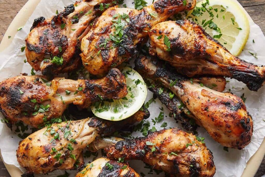 Grilled chicken drumsticks close up shot.