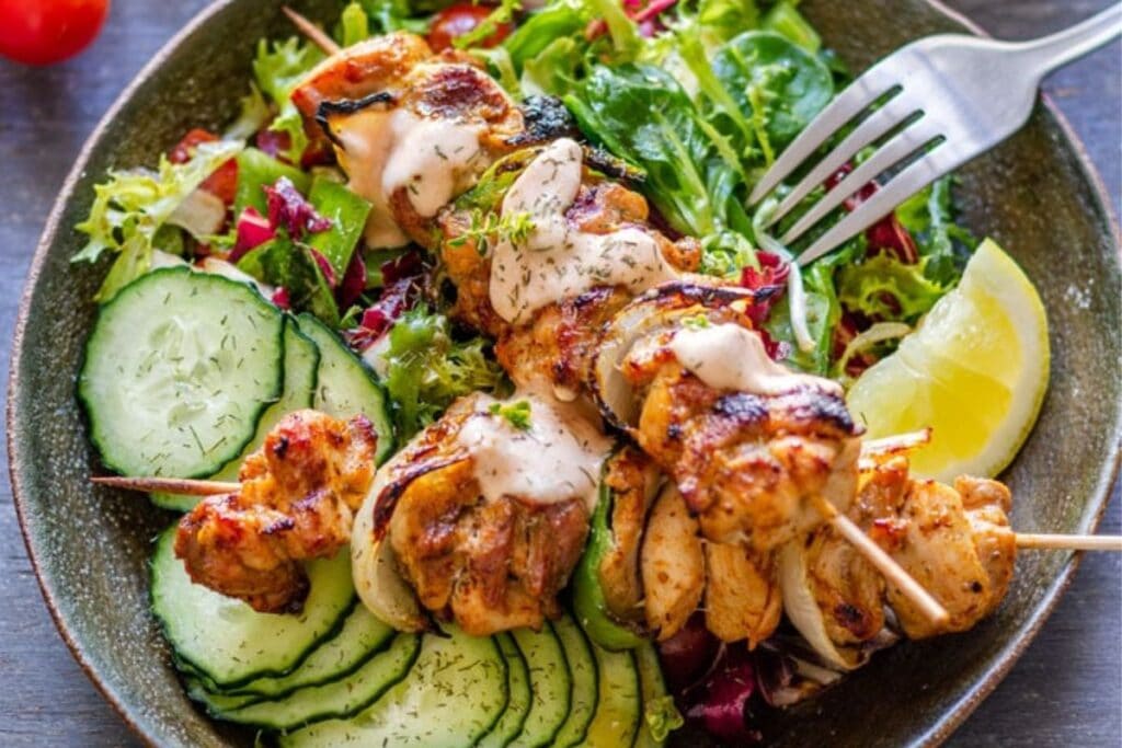 Sliced chicken kabobs with veggies.