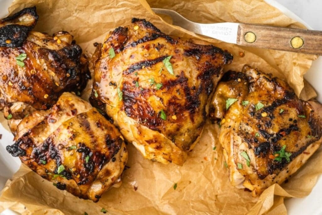 Grilled chicken thighs close up shot.