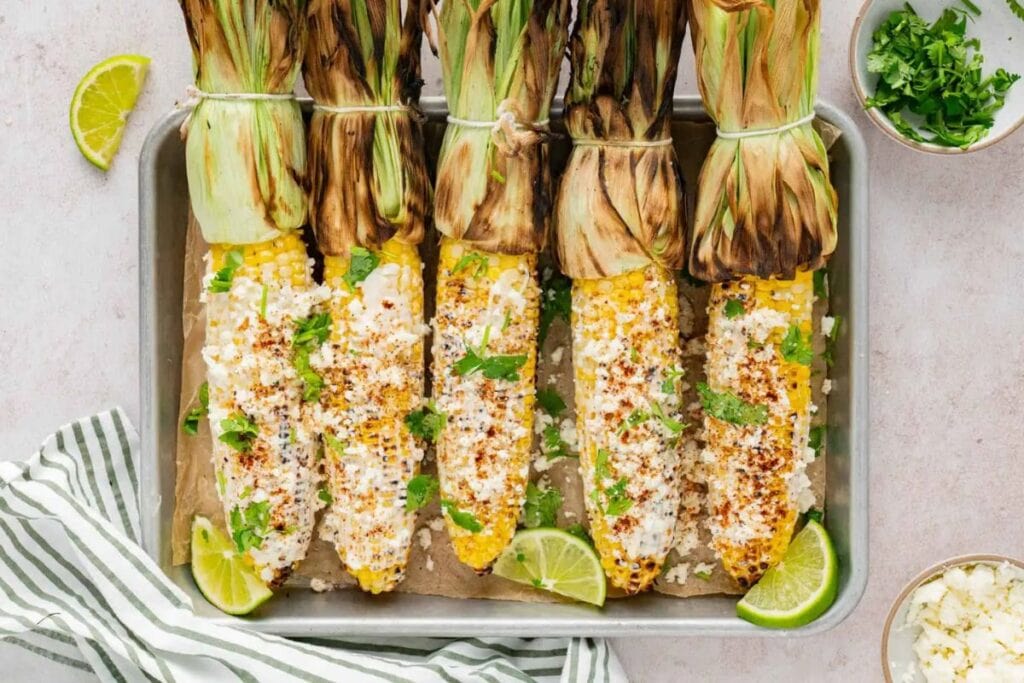 Grilled corns on a tray.