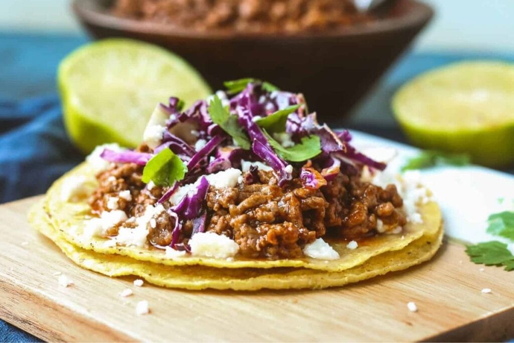 Beef tostadas on a wooden board.