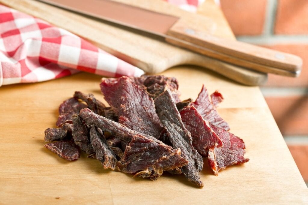 Jerky sticks on a wooden board.