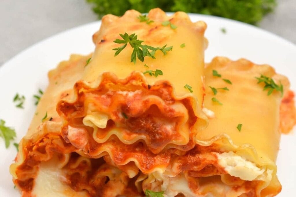 Lasagna roll ups on a plate.