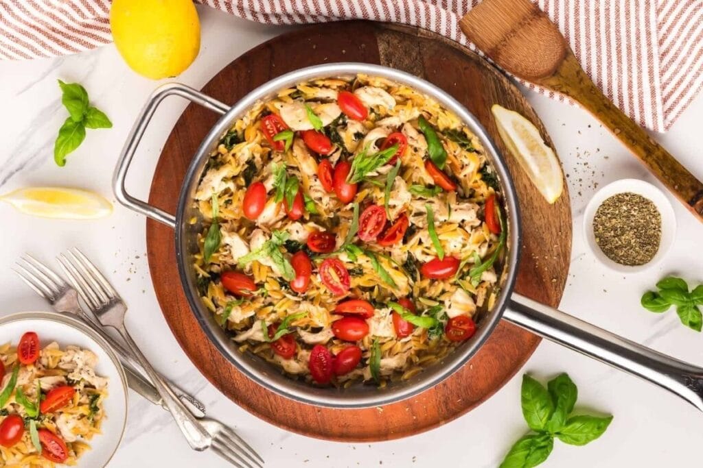 Lemon chicken orzo pasta in a pan.