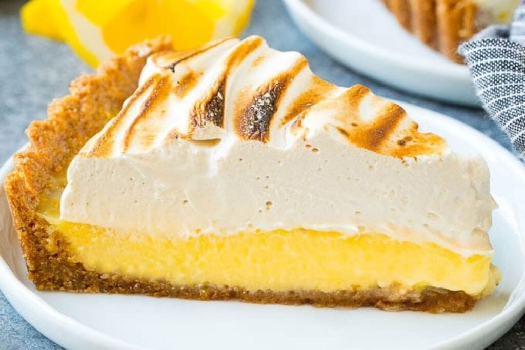 Sliced lemon tart on a plate.