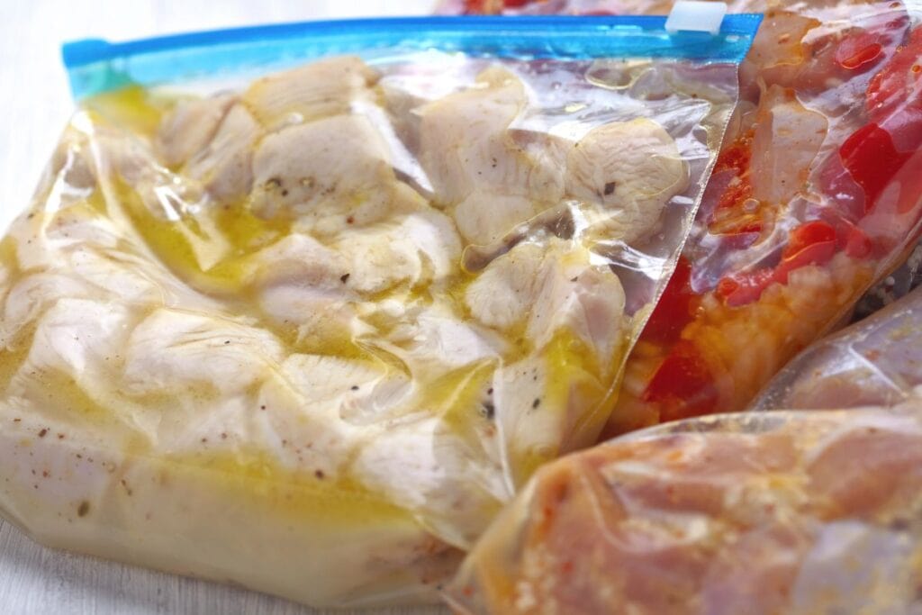 Meat marinating in plastic bags.