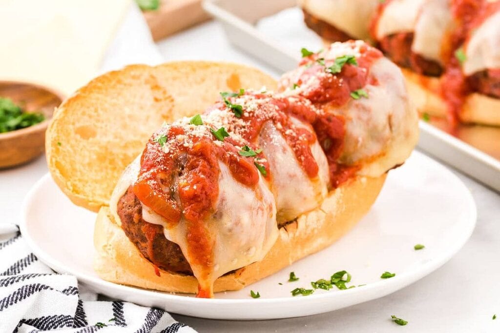 Meatball subs on a plate.