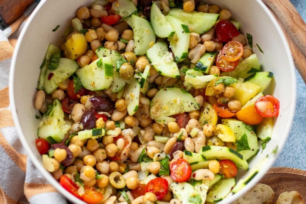 A bowl of mediterranean dense bean salad.