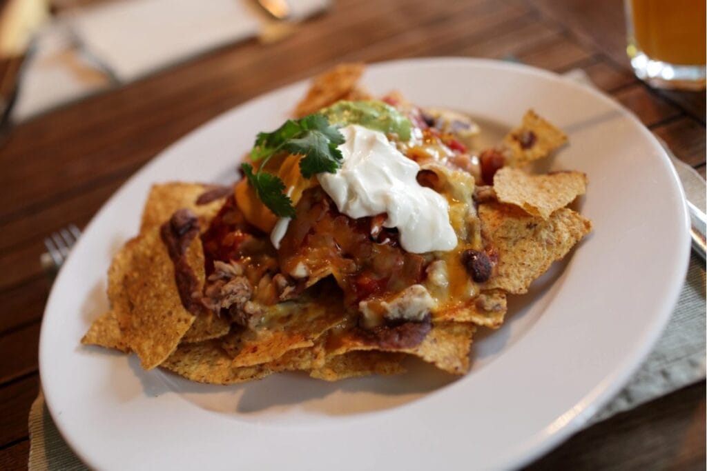Microwave nachos on a plate.