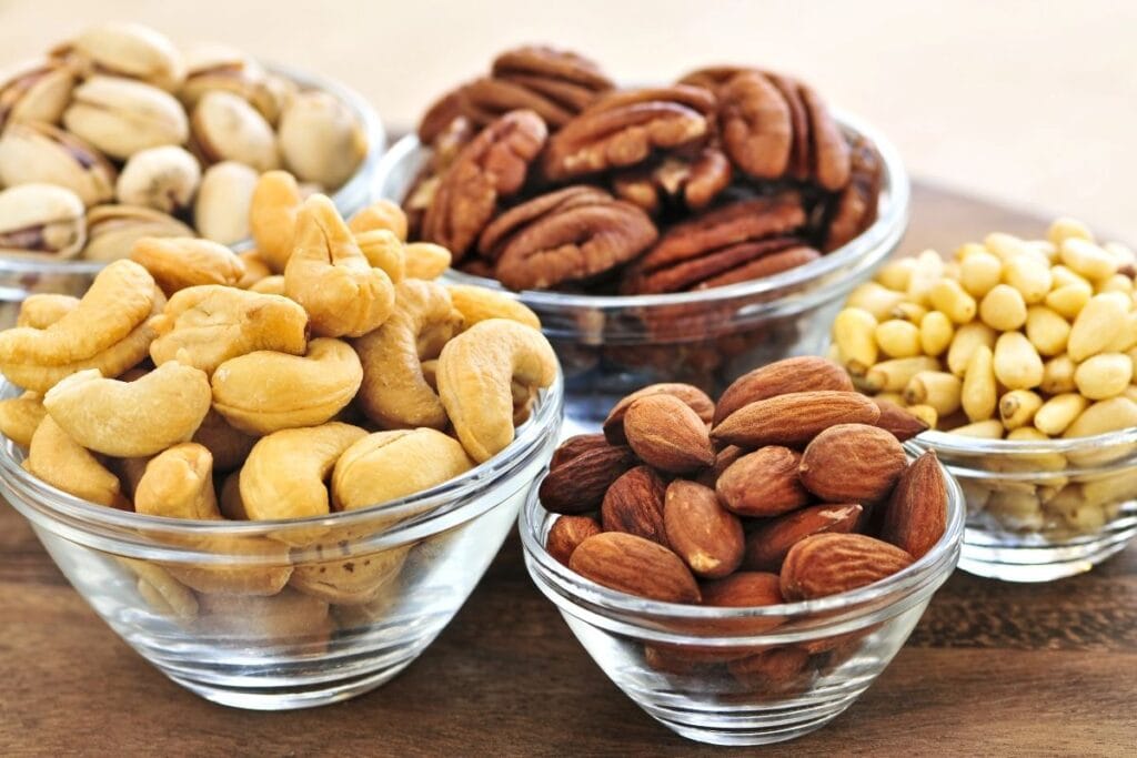 Different kinds of nuts in bowls.