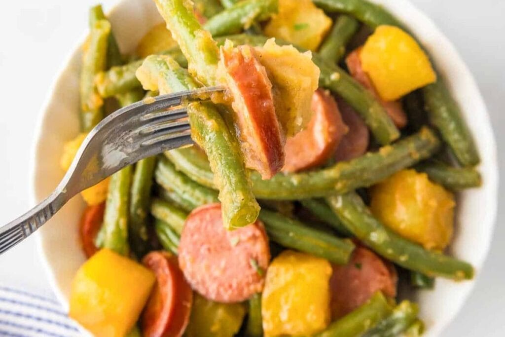 Sausage and green beans potatoes in a bowl.
