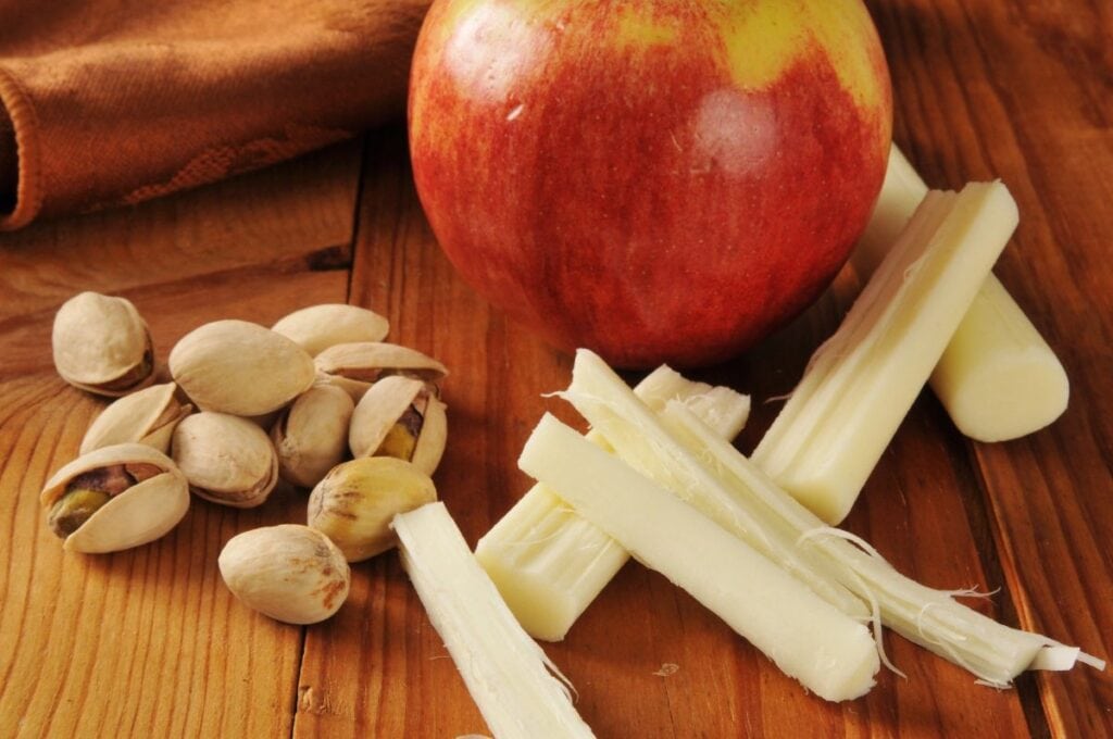 String cheese and nuts close up shot.