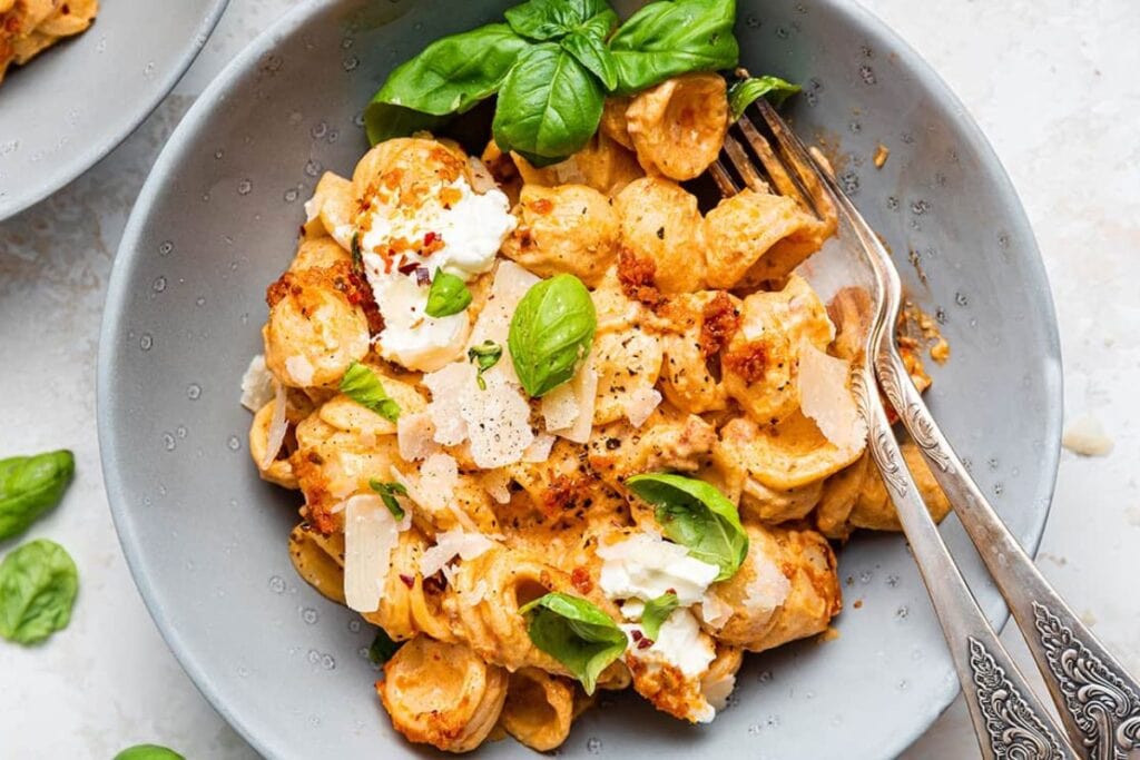 Tomato pesto pasta on a plate.