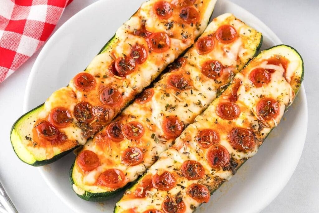 Zucchini pizza boats on a plate.