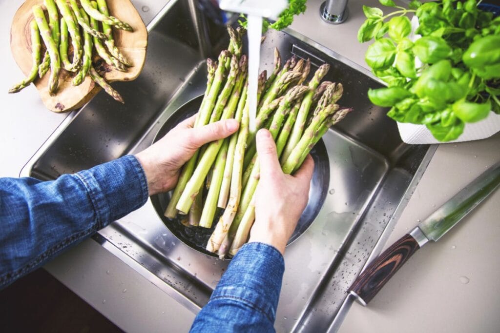 Person washing produce.
