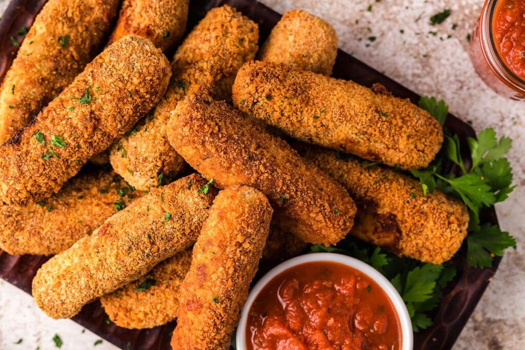 Chicken mozzarella sticks with dip o the side.