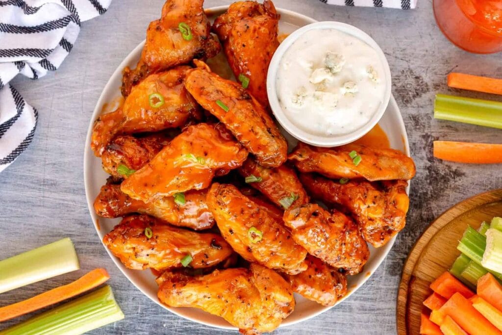 Chicken wings with dip on the side.