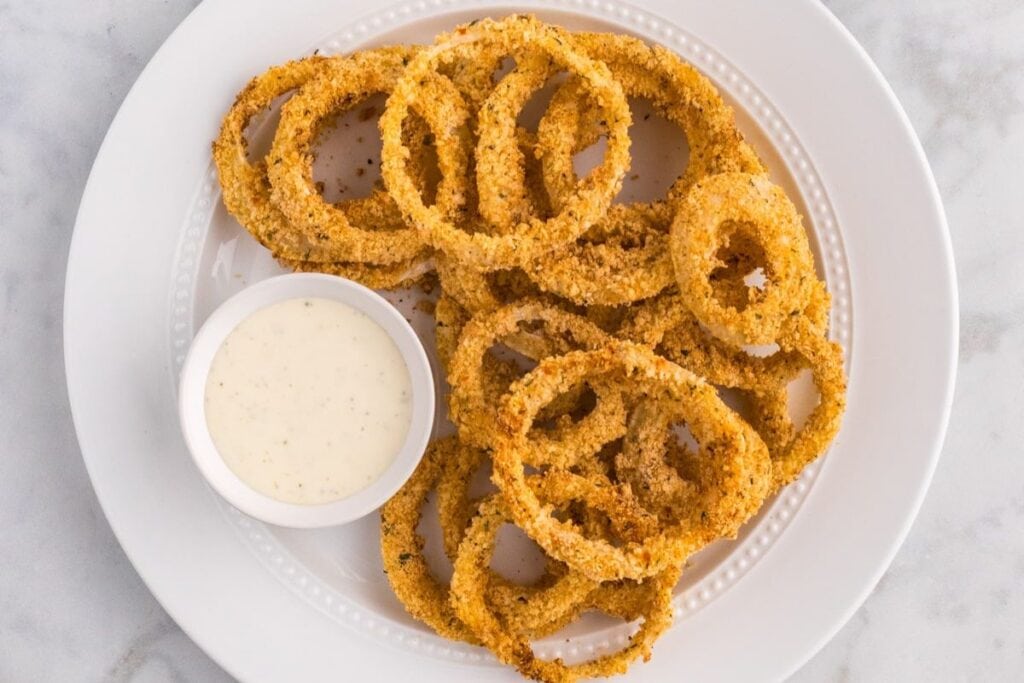 Onion rings with dip on the side.