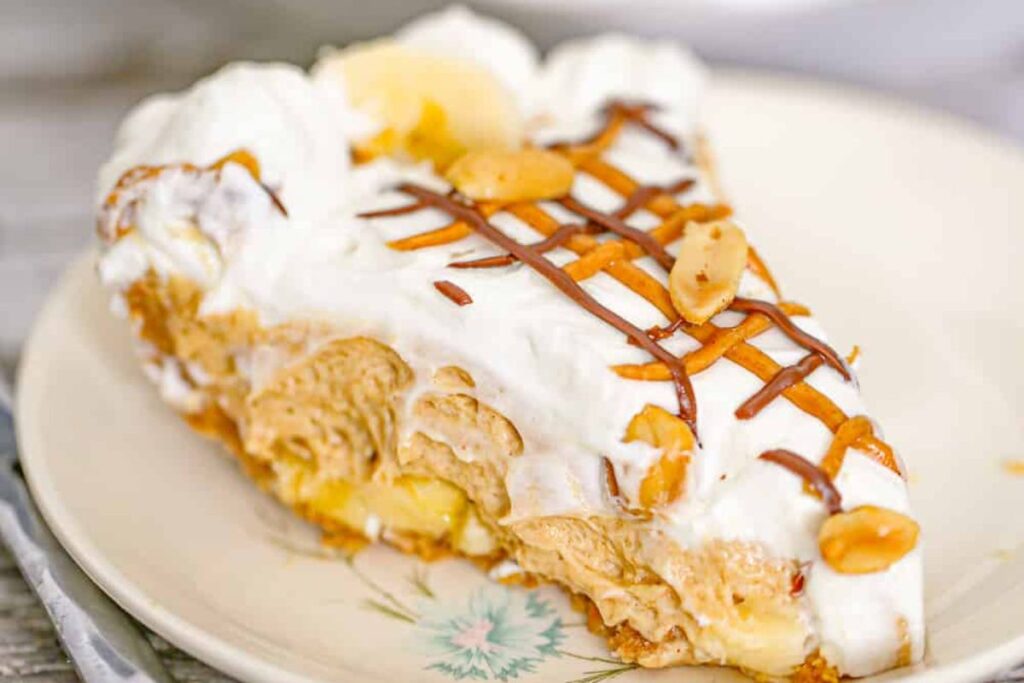A slice of banana peanut butter cream pie on a plate.