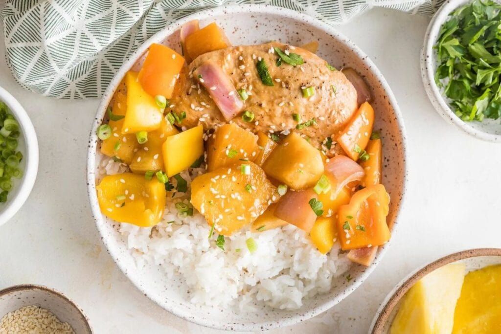 Chicken with pineapple and rice on a plate.