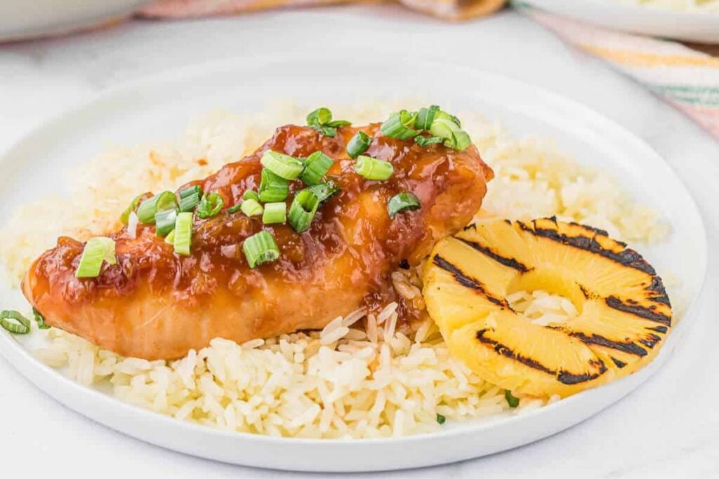 Chicken with rice and sliced pineapple.