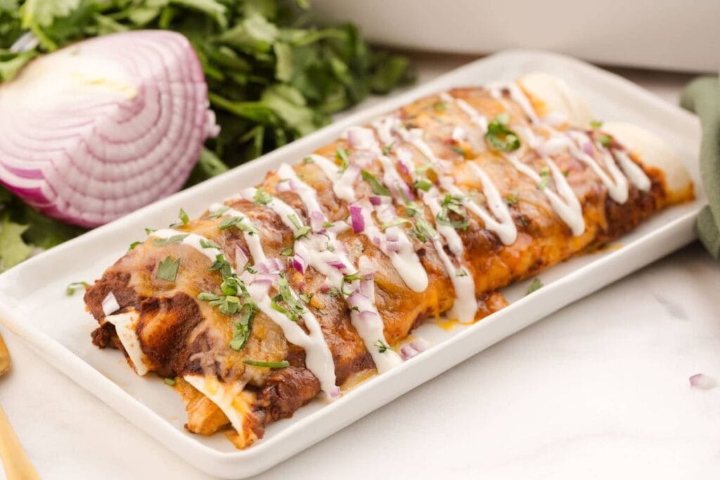 Chicken enchiladas on a plate.