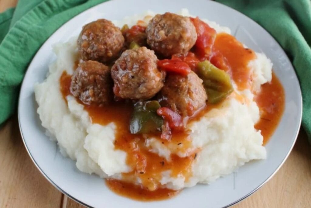 Meatballs with mashed potatoes on a plate.