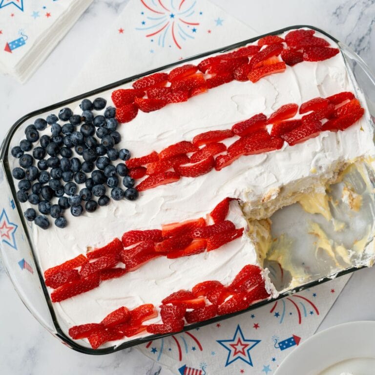 Flag icebox cake filled with banana pudding and Nila wafers on a marble background with 4th of July napkins.