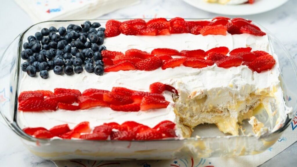 Flag cake sliced into showing pudding layer in baking tray.