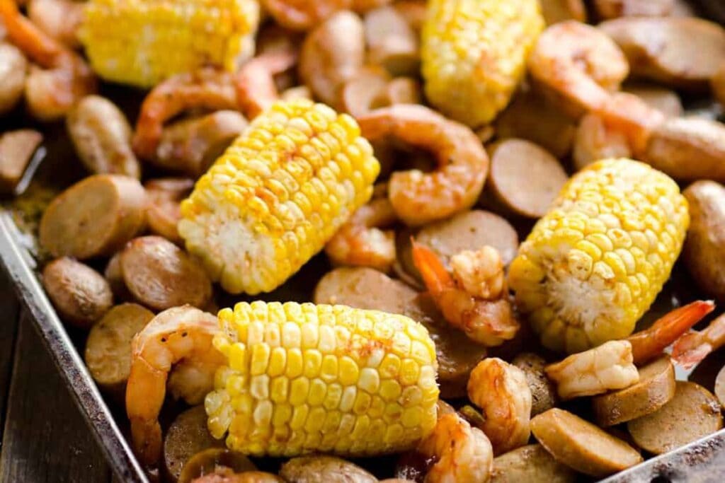 Shrimp and sausage with corns on a sheet pan.