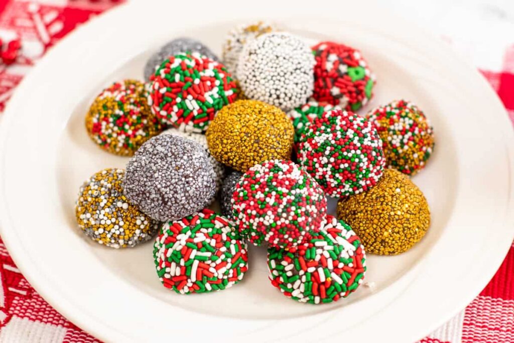 Brownie truffles with sprinkles on a plate.