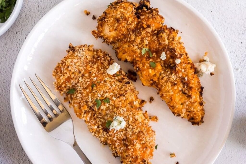 Chicken tenders on a plate.