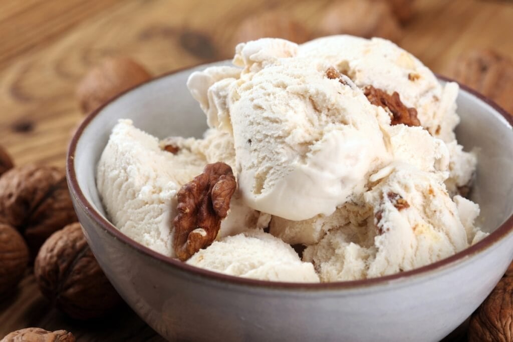 Close-up of butter pecan ice cream in a bowl.