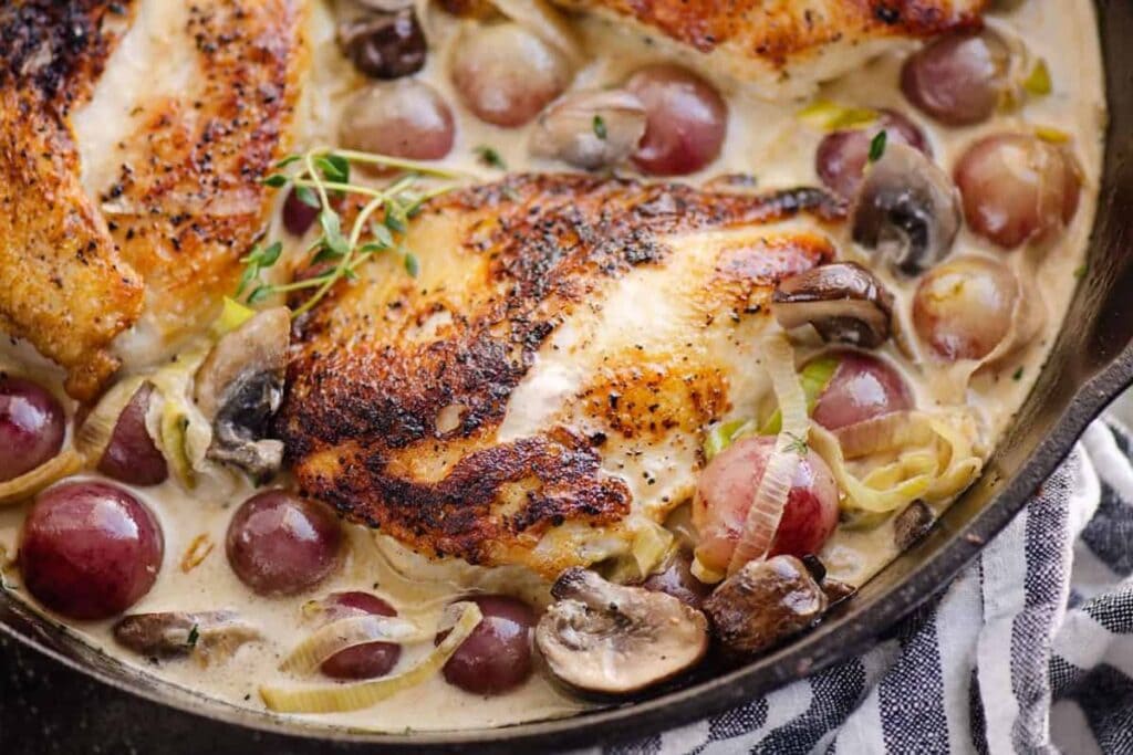 Chicken with grapes close up shot.