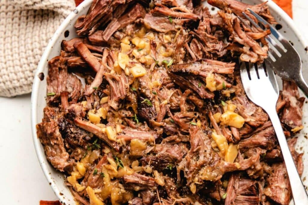 Garlic pot roast in a bowl.