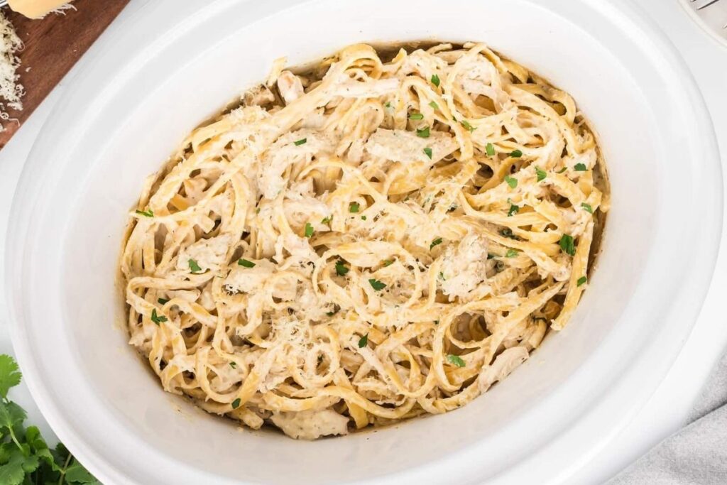 Chicken Alfredo in a white deep bowl.