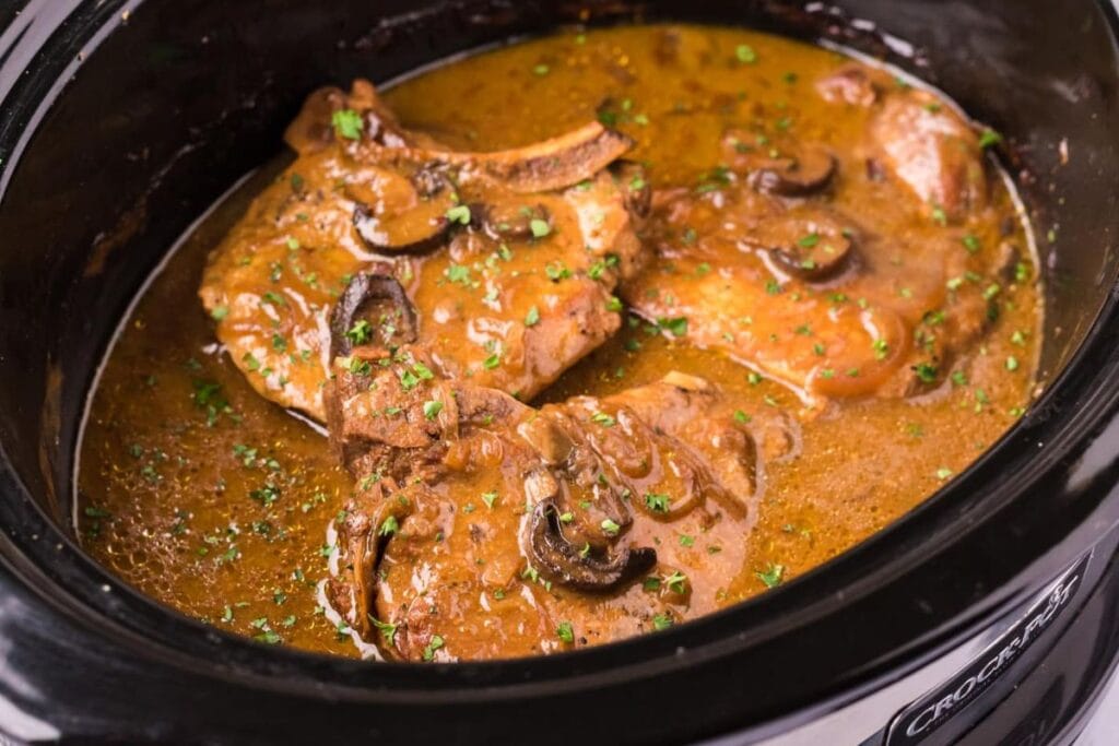 Pork chops with gravy in a crockpot.