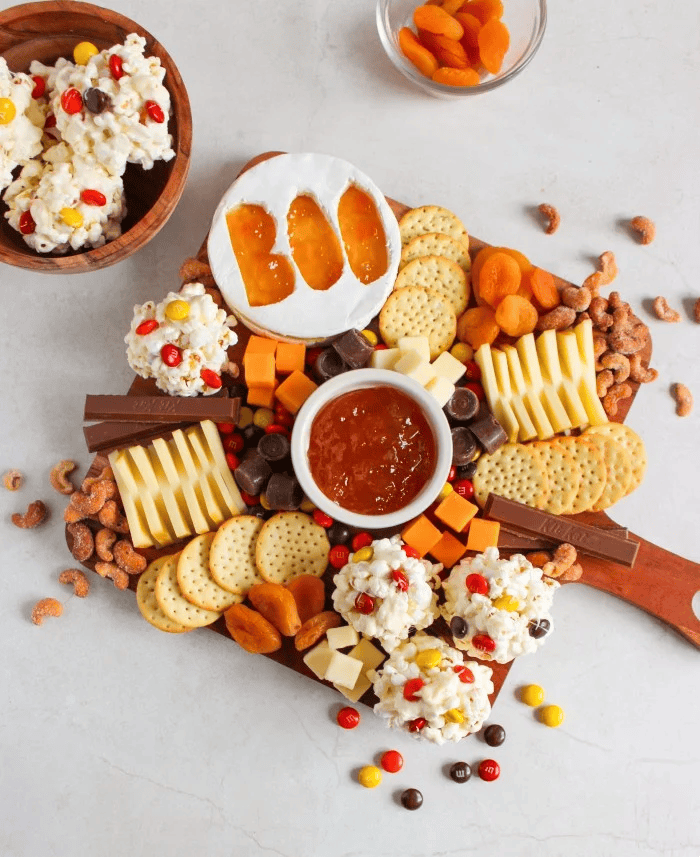 Charcuterie board with popcorn balls.